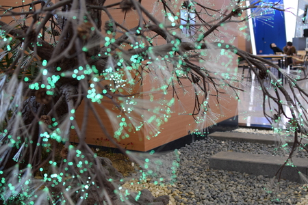 glowing green optical fibers attached on tree