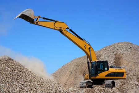Dredge loads a rubble against the blue skyの写真素材