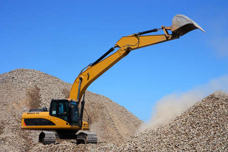 Dredge loads a rubble against the blue skyの写真素材