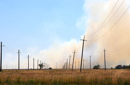 Smoke from the fire of the steppe near settlement