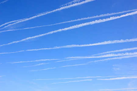 Blue sky with many contrailsの写真素材