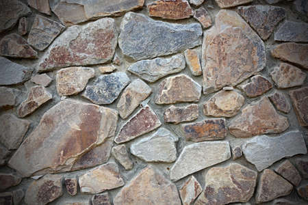 Stone wall with vignette as background. color photoの写真素材