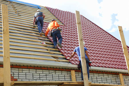 Roofers make the roof of metal tileの写真素材