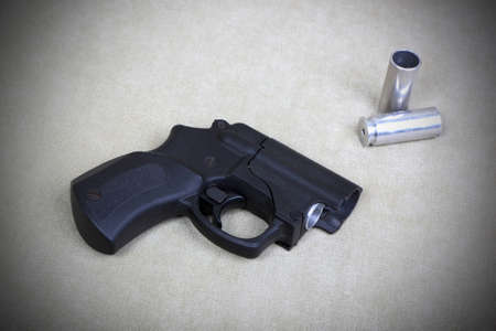 Tubeless doubly charged traumatic gun and two cartridges. Image with vignetteの写真素材