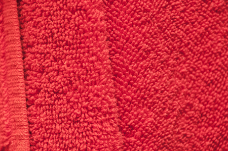 Wavy dry bath towels of color red hanging in bathroom close-upの写真素材
