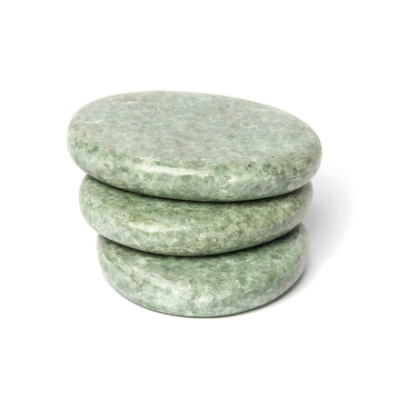 Three greenish polished jadeite stones for spa massage isolated on white background