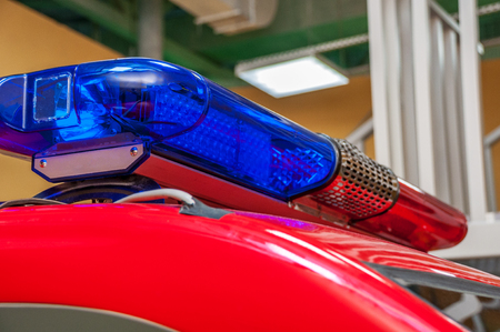 Red blue warning with long siren on car roof standing in garage turned blue side closeup with...