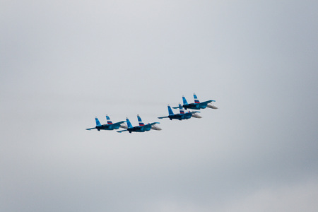 Military aircraft showing a group of aerobatics in the skyの写真素材