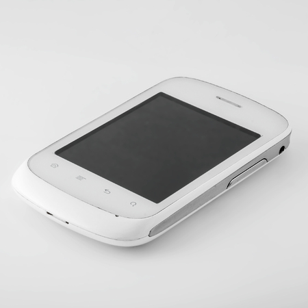 A white smartphone with a blank black screen turned off lies on a white surface with a shadow.
