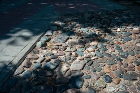 Old-style cobblestone walkway and modern-style tile sidewalkの写真素材