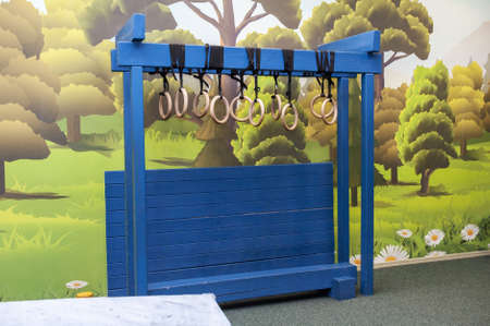 Obstacle course in the children's park. Wooden wall with rings for stamina and dexterityの写真素材