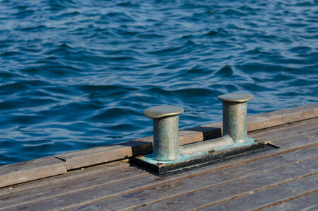 The double mooring bollard on a wooden pier