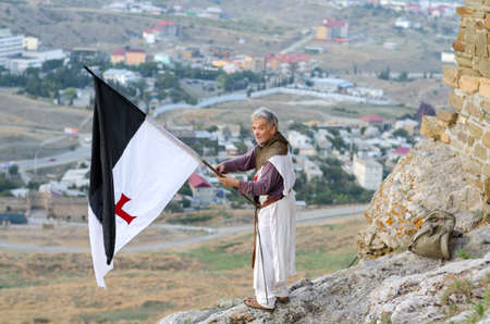Sudak, Crimea - August 14: The knight with flag on the Genoa fortress on August 14, 2015  in Sudak,...