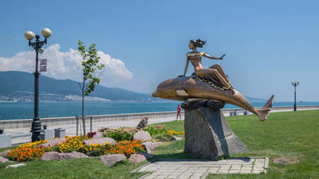 Novorossiysk, Russia - July 9: Woman and dolphin's sculpture in Novorossiysk on July 9, 2018 in Novorossiysk, Russia.のeditorial素材