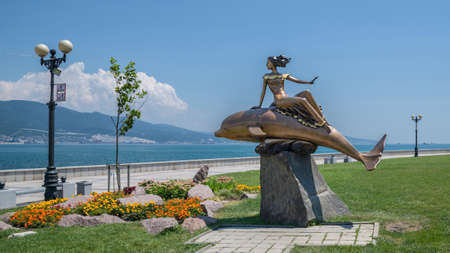 Novorossiysk, Russia - July 9: Woman and dolphin's sculpture in Novorossiysk on July 9, 2018 in Novorossiysk, Russia.のeditorial素材