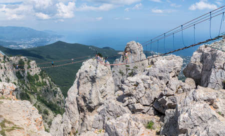 Alupka, Crimea - July 22: Rope ladder above precipice at the Ai-Petri mountain on July 22, 2018 in Alupka, Crimea.のeditorial素材
