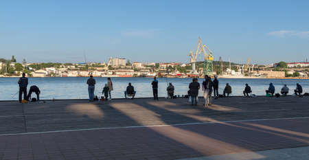 Sevastopol, Crimea - May 12: Fishermans at quay in Sevastopol on May 12, 2018 in Sevastopol, Crimea.のeditorial素材