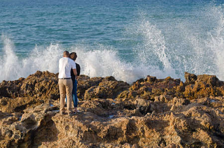 Port Elizabet, South Africa - September 12: Pair of lovers observe a waves break in the Port Elizabet on September 12, 2015 in Port Elizabet, South Africa.のeditorial素材