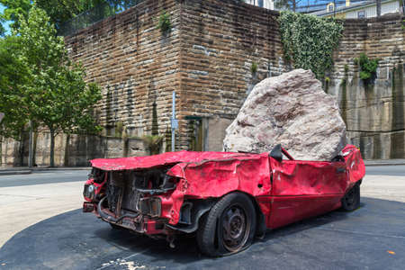 Big and heavy stone crush a red carのeditorial素材