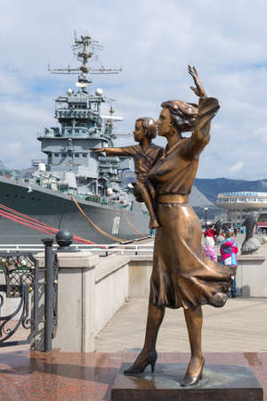 Novorossiysk, Russia - March 25: Woman with child waiting for a seaman sculpture in Novorossiysk on March 25, 2019 in Novorossiysk, Russia.のeditorial素材