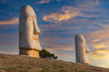Sudak, Crimea - May 05: Moai statues at the foot of mount Alchak-Kaya on May 05, 2021 in Sudak,...