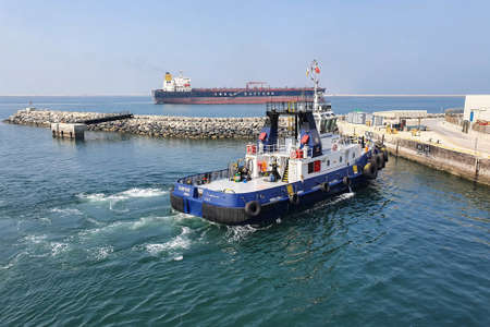 Jebel Ali, United Arab Emirates - October 09: Tugboat on the berth in port of Jebel Ali on October 09, 2021 in Jebel Ali, United Arab Emirates.のeditorial素材