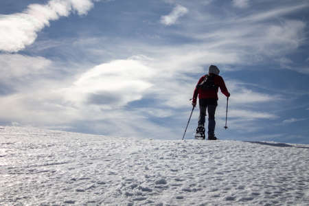 Ascent to Pico de la Miel in the Cantabrian Mountains, Espinosa de los Monteros -Burgos Spain, snowshoeing on a sunny snowy day.の写真素材