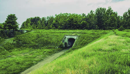 Log into the tunnel. Under the mountain in the plain. Old Fort. War. Nature. Landscape