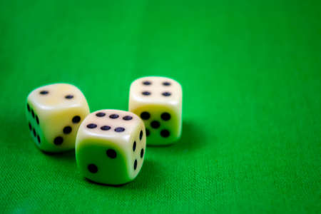 3 cubes dices on green background