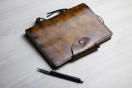 Flatlay of the broun leather notebook on the light backgroundの写真素材