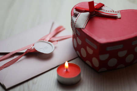 Romantic flatlay with candle, letter and heart boxの写真素材