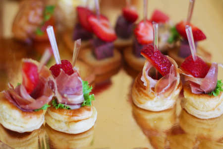 Tasty dessert with dough, fruit and meat on the banquet