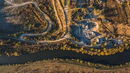 Large quarry dumper near the river and forestの写真素材