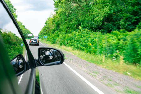 Front side view of black car in turn. Mirror. Forestの写真素材