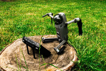 The drone is off lying on the stump.Grey copter in assembled ready condition. Funny momentの写真素材