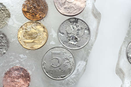 Dollar and ruble in ice cubes, ice concept, frozen assets, sanctions, frozen ruble