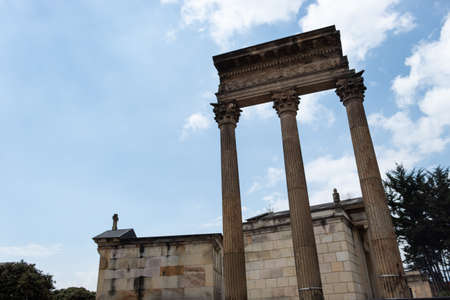 Three ancient pillars, old crypts and mausoleums located in Cementerio central downtown city in sunny dayの写真素材