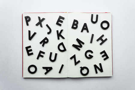 Close up to lettering over blank notebook at white background. Reading and study concept photographyの写真素材