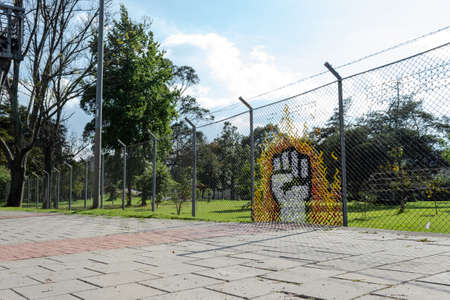 A Closed Fist Streetart formed with clothes into a metal grid at Bogotáのeditorial素材