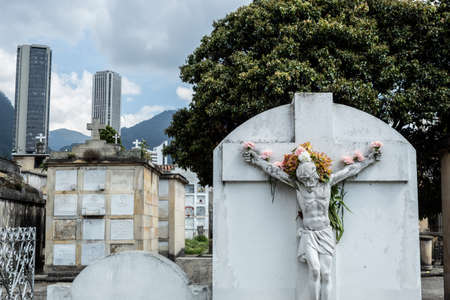 Crucified JesusChrist Stone adorned with multicolor flowers like a crown into Central Cemetery....