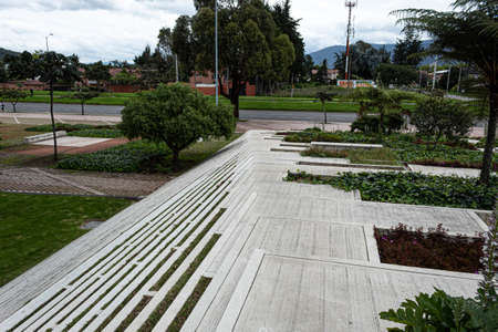 Geometric pattern of a modern street stairways with green gardens, trees and nature architecture. A highway at backgroundの写真素材