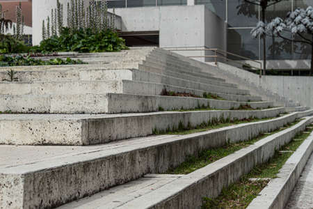 Close up to a Geometric pattern of a modern white street stairways with green grass, trees and nature architecture.の写真素材
