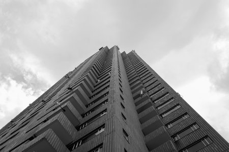 BOGOTA, COLOMBIA - Low angle view of a brick symmetrical skyscraper corner with cloudy sky at...