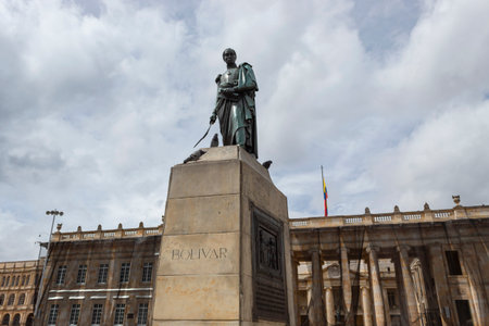BOGOTA, COLOMBIA Closeup to a Simon Bolivar monument located at downtown simon bolivar square with presidential palace behind and blue cloudy sky at backgroundのeditorial素材