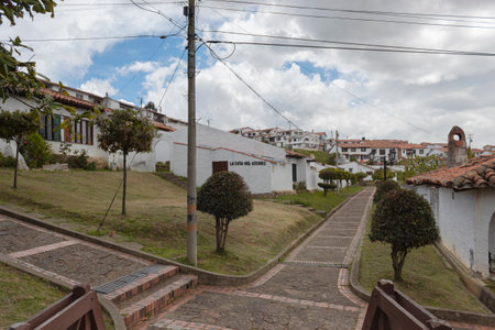 GUATAVITA, COLOMBIA Peatonal path and colonial architecture details of town houses with cloudy skyのeditorial素材