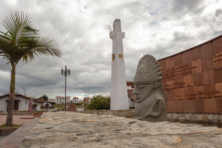 GUATAVITA, COLOMBIA - Guatavita native chief monument into waterfont and clock tower and cloudy day at backgroundのeditorial素材