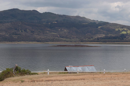 Guatavita tomine lake view with mountains and blue sky at backgroundの写真素材