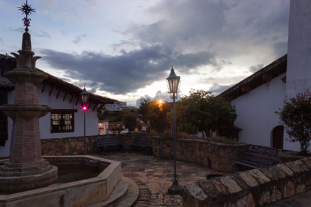 Beautiful shot of colombian colonial town with waterfont square, town lights at blue hour afternoon.の写真素材
