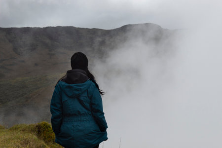 Closeup to a young woman with a wool cap watching in relaxing form the colombian badland mountain...