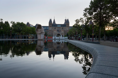 Beautiful shot of Rijkmuseum with im Amsterdam lettering sign reflecte on waterのeditorial素材